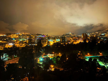 High angle view of illuminated buildings in city at night