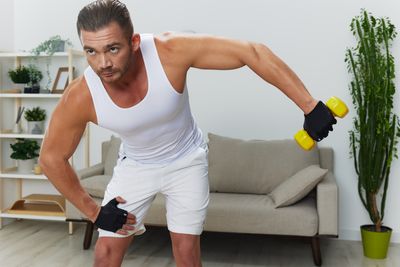 Full length of man exercising in gym