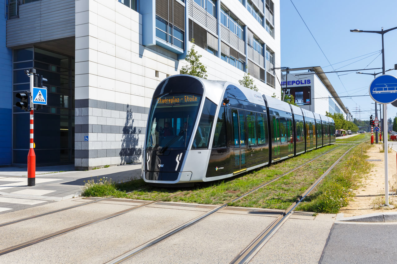 TRAIN ON RAILROAD TRACK IN CITY