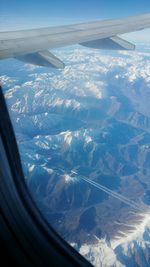 Aerial view of landscape seen through airplane window