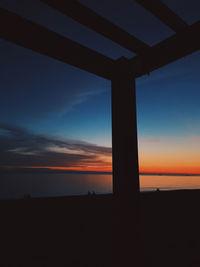 Scenic view of silhouette land against sky at sunset