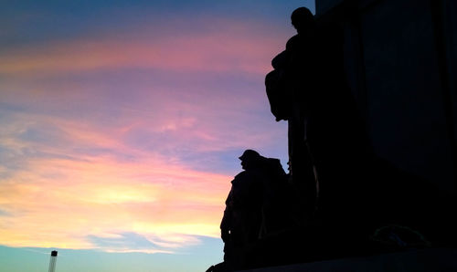 Low angle view of silhouette trees against sky at sunset