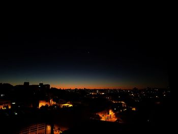 High angle view of illuminated buildings against sky at night