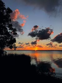 Scenic view of lake against romantic sky at sunset