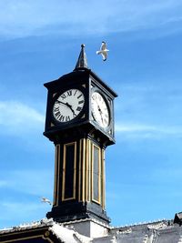 Low angle view of clock tower against sky