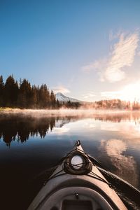 Cropped image of boat on lake against sky