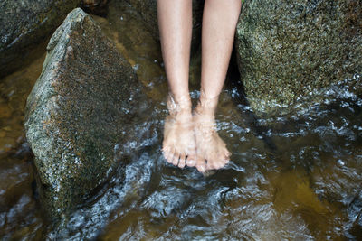 Low section of woman in river