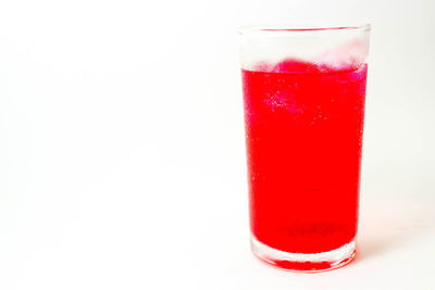 Close-up of red glass against white background