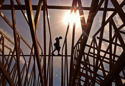 Low angle view of silhouette worker