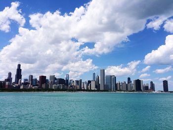 Sea and cityscape against sky