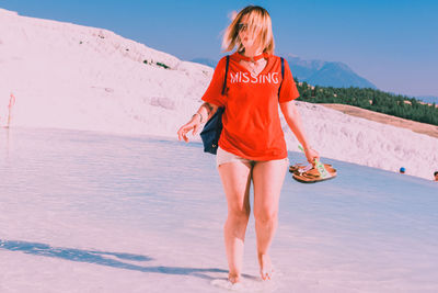 Full length of woman standing on beach