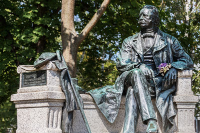 Statue of cemetery against trees