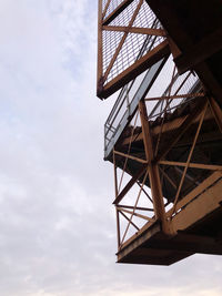 Low angle view of steel bridge against sky