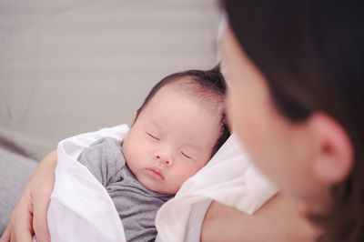 Mother with baby on bed