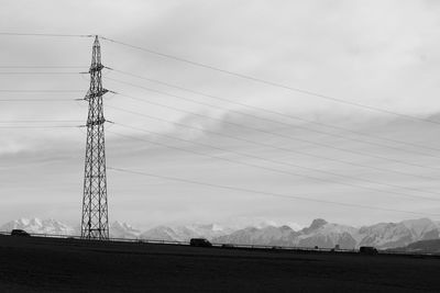 Low angle view of electricity pylon against sky