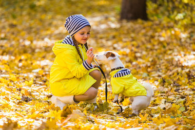 Boy with yellow umbrella during autumn