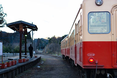 Train on railroad tracks against clear sky