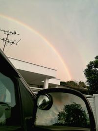 Rainbow over trees against sky