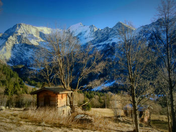 Low angle view of mountains in front of field during winter