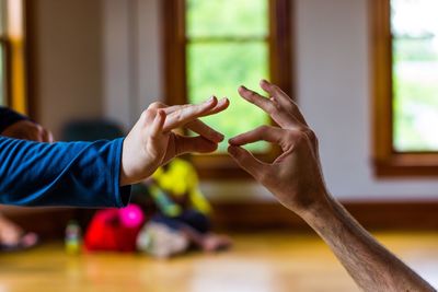 Cropped image of father and son gesturing at home