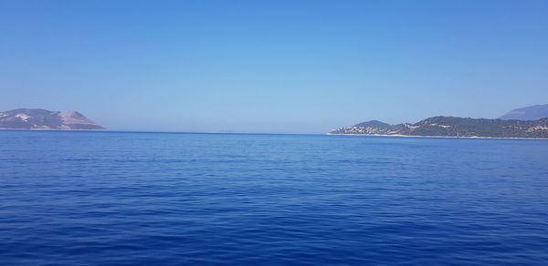 Scenic view of sea against clear blue sky