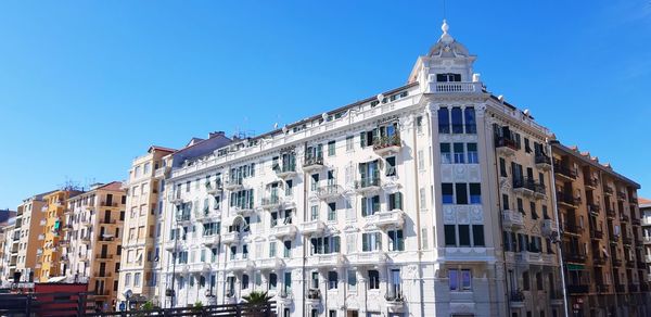 Low angle view of buildings against blue sky