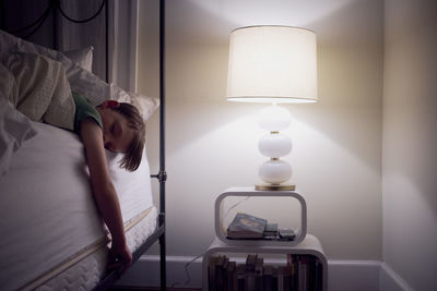 Boy sleeping on bed at home