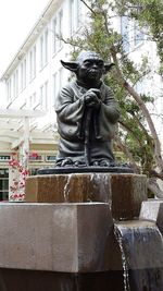 Low angle view of statue against built structure