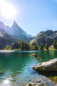 Scenic view of lake and mountains against clear sky