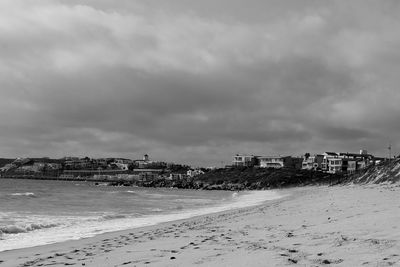 Scenic view of beach against sky in city