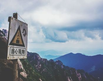 Scenic view of mountains against cloudy sky