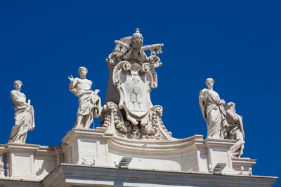 Low angle view of statue against blue sky