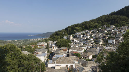 High angle view of townscape by sea against sky