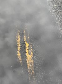 High angle view of wet yellow road