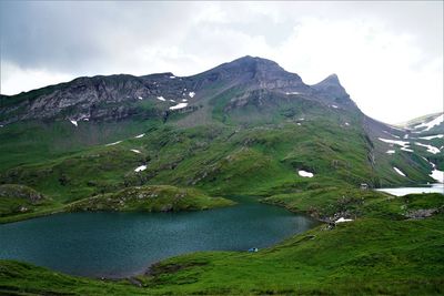 Scenic view of lake and mountains against sky