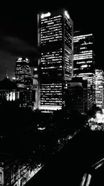 Illuminated modern buildings in city at night