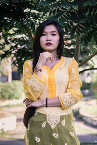 Portrait of young woman standing outdoors