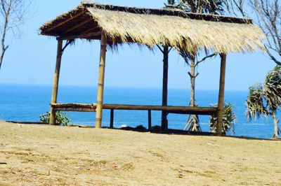 Lifeguard hut on beach against sky