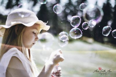 Portrait of young woman in bubbles