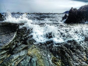 Close-up of waves on sea against sky