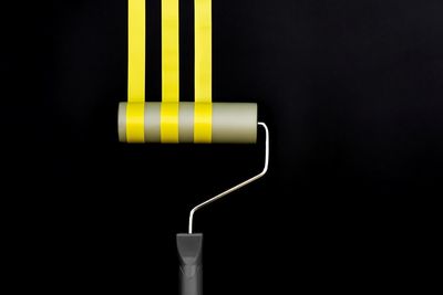 Close-up of illuminated electric lamp against black background