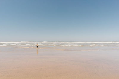 Scenic view of beach against clear sky