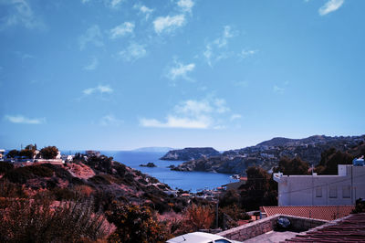 Scenic view of sea and mountains against blue sky