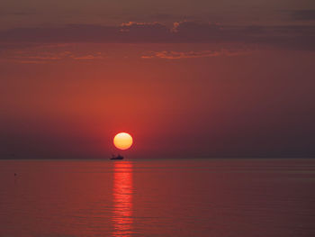 Scenic view of sea against romantic sky at sunset