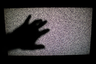 Close-up of human hand on shadow