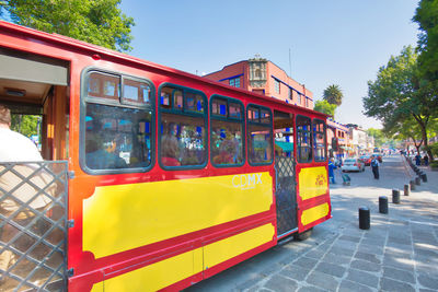 Train on street in city against sky