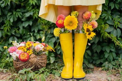 Floral arrangement with rubber boots worn on the feet