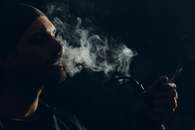 Portrait of man smoking cigarette