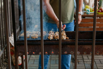 Midsection of person preparing food at market stall