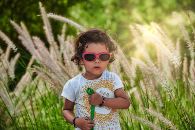 Portrait of boy wearing sunglasses on field